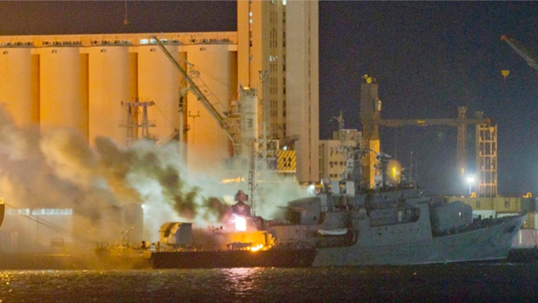 May 20: Smoke and flames pour from the Libyan Navy frigate Al Ghardabia, after it was hit during an airstrike by Tornado bombers of Britain's Royal Force on the port area of Tripoli.