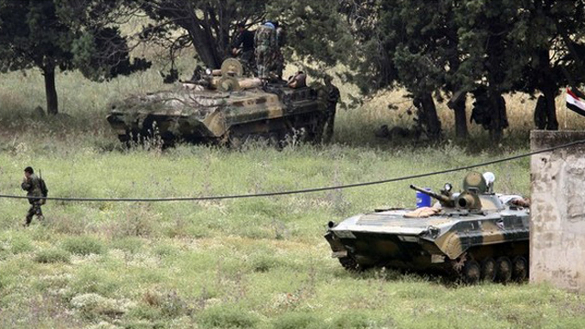 May 20: Syrian soldiers deploy in the Syrian village of Arida, as seen from the northern Lebanese village of Wadi Khaled near the Lebanese-Syrian border.