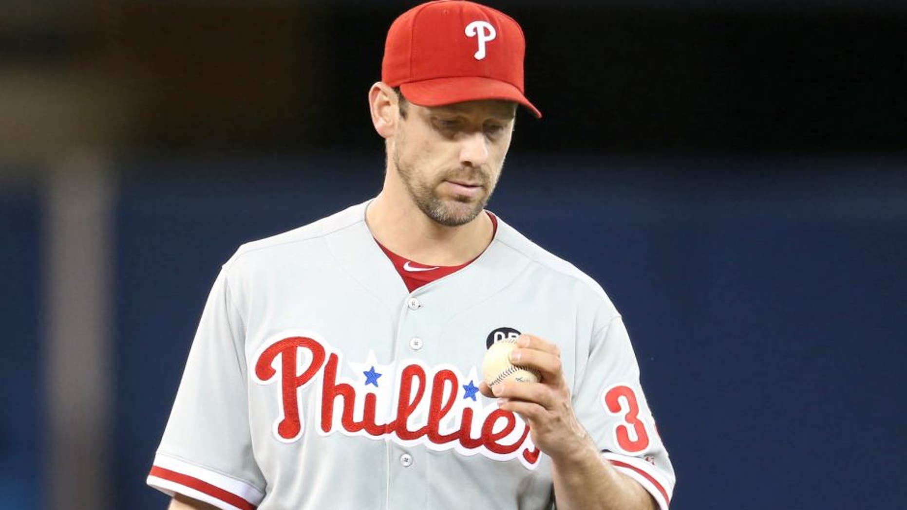 TORONTO, CANADA - MAY 7: Cliff Lee #33 of the Philadelphia Phillies inspects a baseball during MLB game action against the Toronto Blue Jays on May 7, 2014 at Rogers Centre in Toronto, Ontario, Canada. (Photo by Tom Szczerbowski/Getty Images)