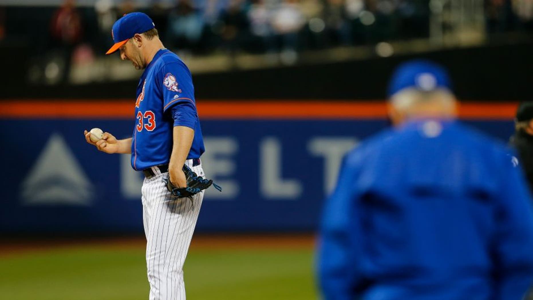 NEW YORK, NY - MAY 19: Pitcher Matt Harvey #33 of the New York Mets stares at the ball as manager Terry Collins #10 comes out to relieve him during the third inning of a game at Citi Field on May 19, 2016 in the Flushing neighborhood of the Queens borough of New York City. (Photo by Rich Schultz/Getty Images)