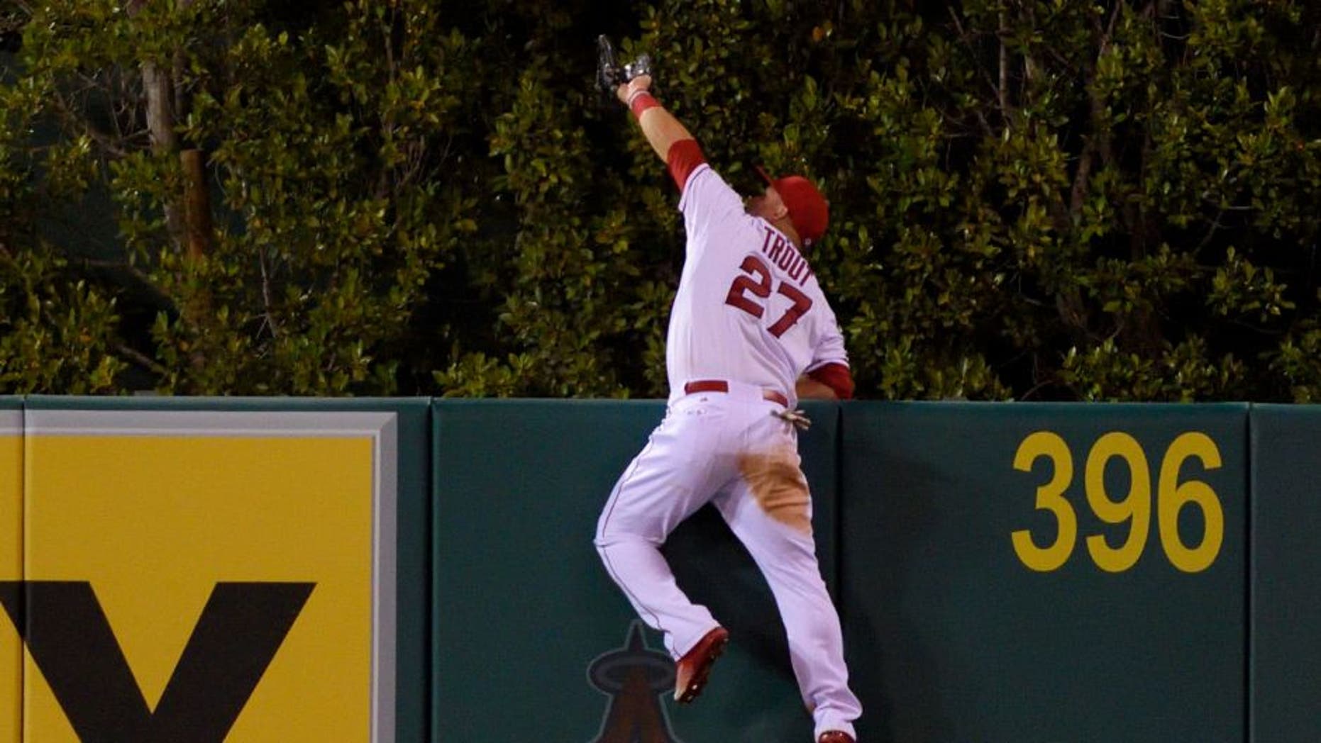 ANAHEIM, CA - SEPTEMBER 26: Mike Trout #27 of the Los Angeles Angels of Anaheim makes a catch high over the wall to rob Jesus Montero of the Seattle Mariners of what would have been a three-run home run during the fourth inning of the game against the Seattle Mariners at Angel Stadium of Anaheim on September 26, 2015 in Anaheim, California. (Photo by Matt Brown/Angels Baseball LP/Getty Images)