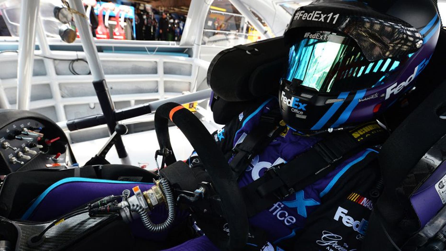 DOVER, DE - MAY 14: Denny Hamlin, driver of the #11 FedEx Office Toyota, sits in his car during practice for the NASCAR Sprint Cup AAA 400 Drive For Autism at Dover International Speedway on May 14, 2016 in Dover, Delaware. (Photo by Drew Hallowell/NASCAR via Getty Images)