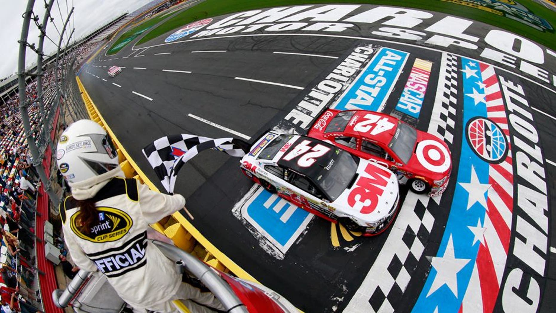 CHARLOTTE, NC - MAY 21: Kyle Larson, driver of the #42 Target Chevrolet, takes the checkered flag against Chase Elliott, driver of the #24 3M Chevrolet, to win the third segment of the NASCAR Sprint Cup Series Sprint Showdown at Charlotte Motor Speedway on May 21, 2016 in Charlotte, North Carolina. (Photo by Matt Sullivan/NASCAR via Getty Images)