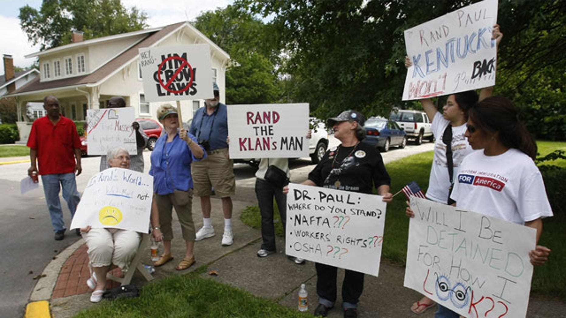May 22: Demonstrators hold signs across the street from a Republican party unity rally in Frankfort, Ky.