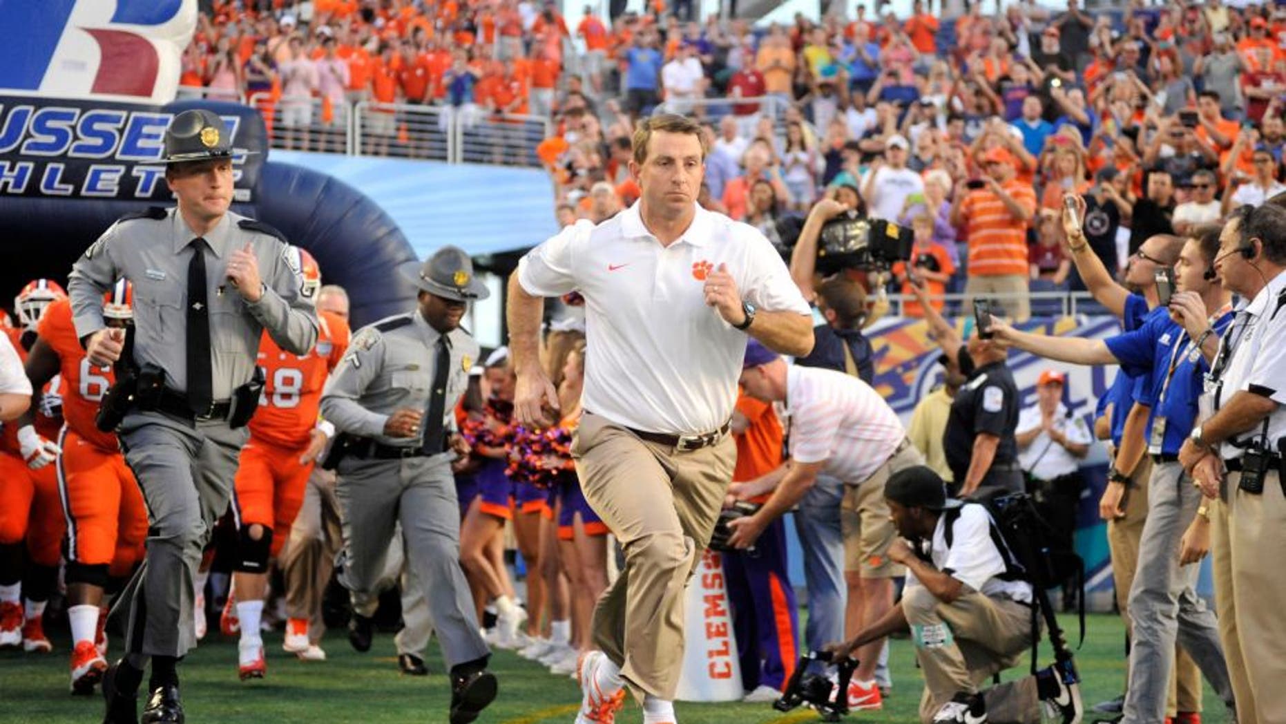 Dec 29, 2014; Orlando, FL, USA; Clemson Tigers head coach Dabo Swinney runs onto the field before the 2014 Russell Athletic Bowl at Florida Citrus Bowl. Mandatory Credit: David Manning-USA TODAY Sports