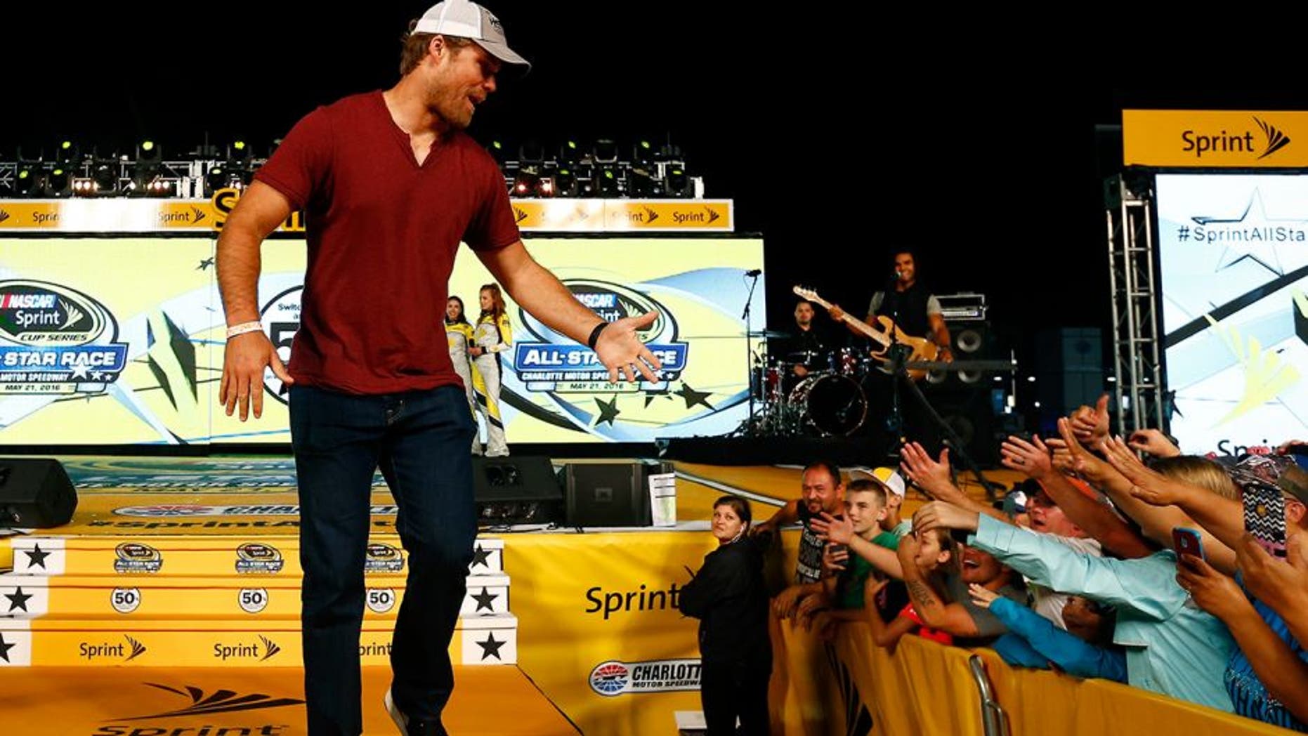 CHARLOTTE, NC - MAY 21: Greg Olsen of the Carolina Panthers is introduced prior to the NASCAR Sprint Cup Series Sprint All-Star Race at Charlotte Motor Speedway on May 21, 2016 in Charlotte, North Carolina. (Photo by Jonathan Ferrey/NASCAR via Getty Images)