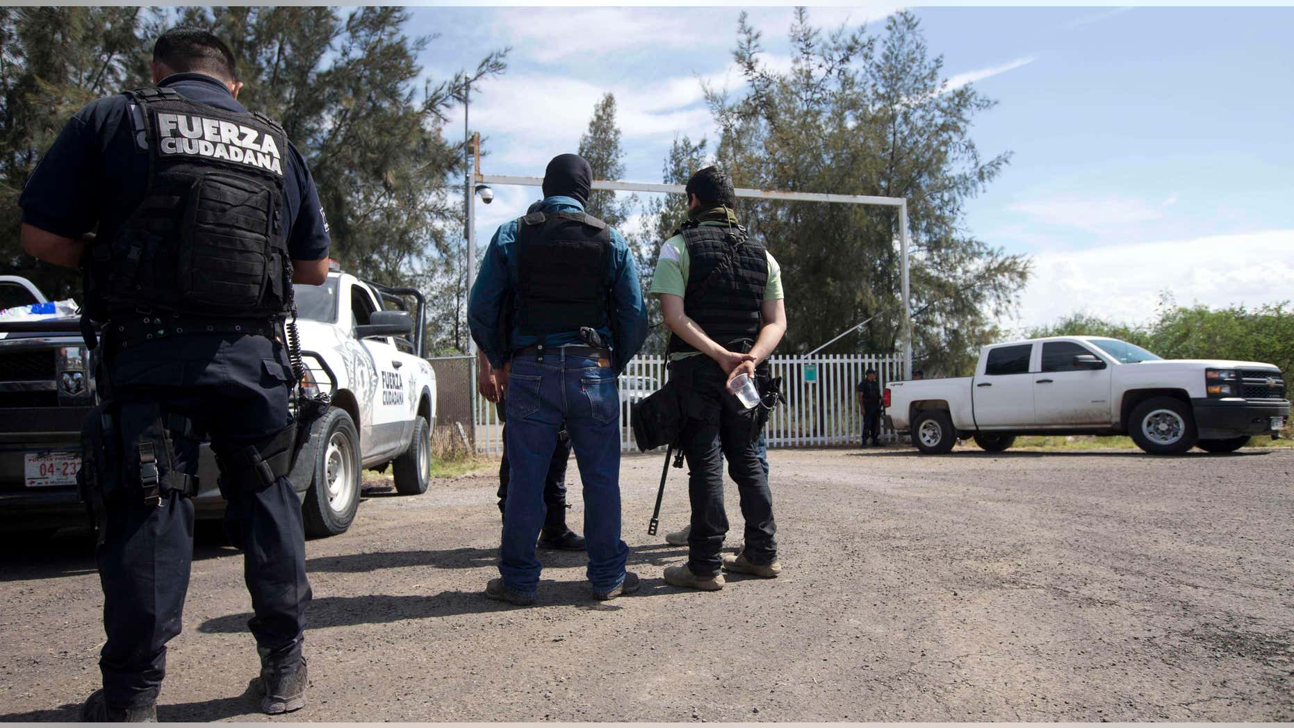 May 22, 2015: Mexican state police stand guard at the entrance of Rancho del Sol, near Vista Hermosa, Mexico.