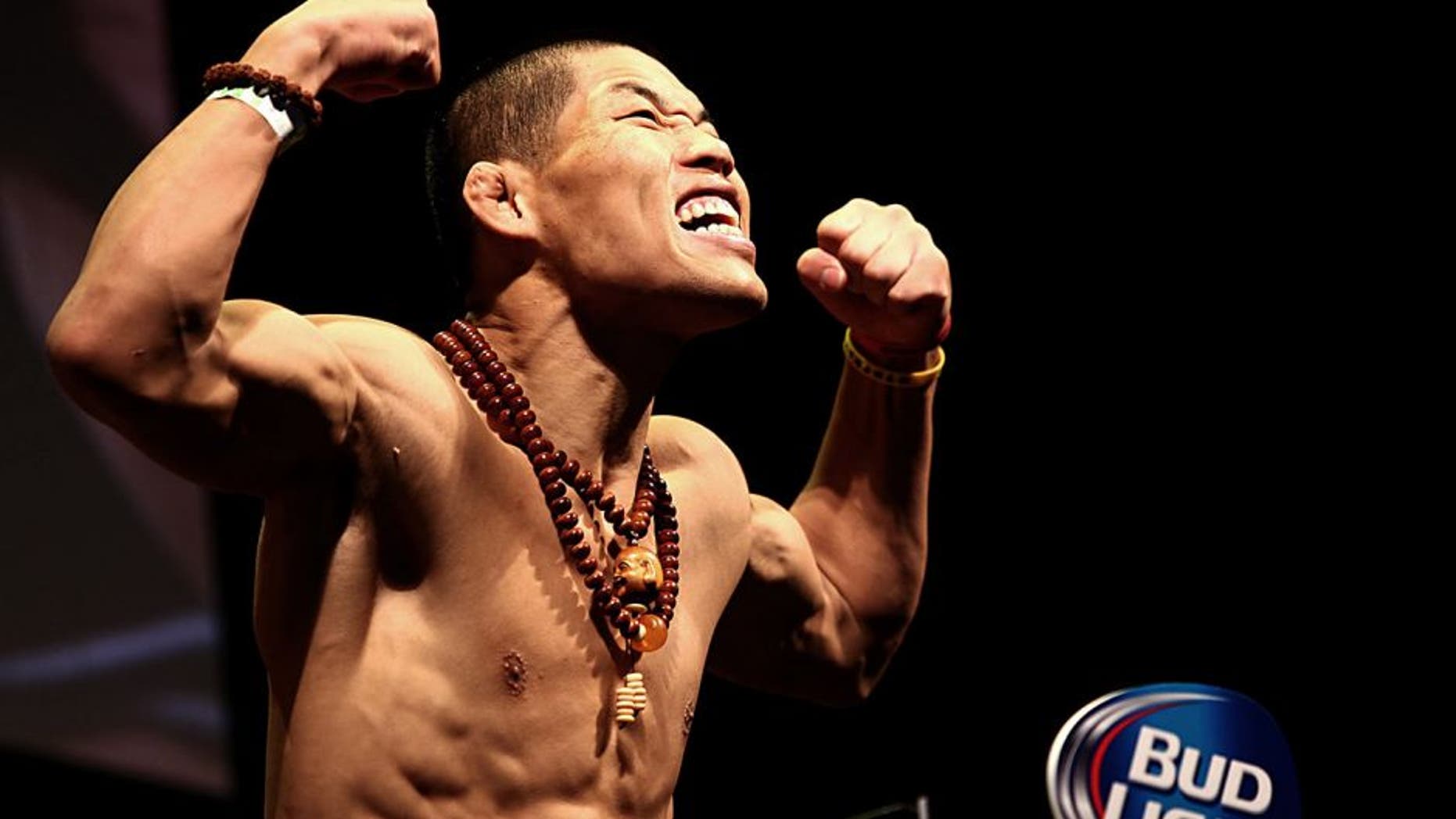 LAS VEGAS, NV - MAY 23: Li Jingliang of China steps on the scale during the UFC 173 weigh-in event at the MGM Grand Garden Arena on May 23, 2014 in Las Vegas, Nevada. (Photo by Brandon Magnus/Zuffa LLC/Zuffa LLC via Getty Images)