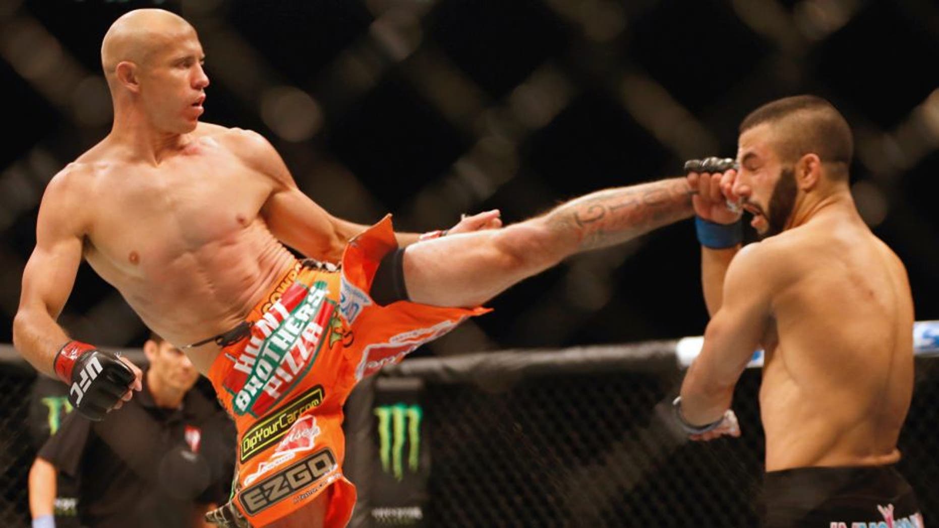 (L-R) Donald Cerrone kicks John Makdessi of Canada in their lightweight bout during the UFC 187 event at the MGM Grand Garden Arena on May 23, 2015 in Las Vegas, Nevada. (Photo by Christian Petersen/Zuffa LLC/Zuffa LLC via Getty Images)