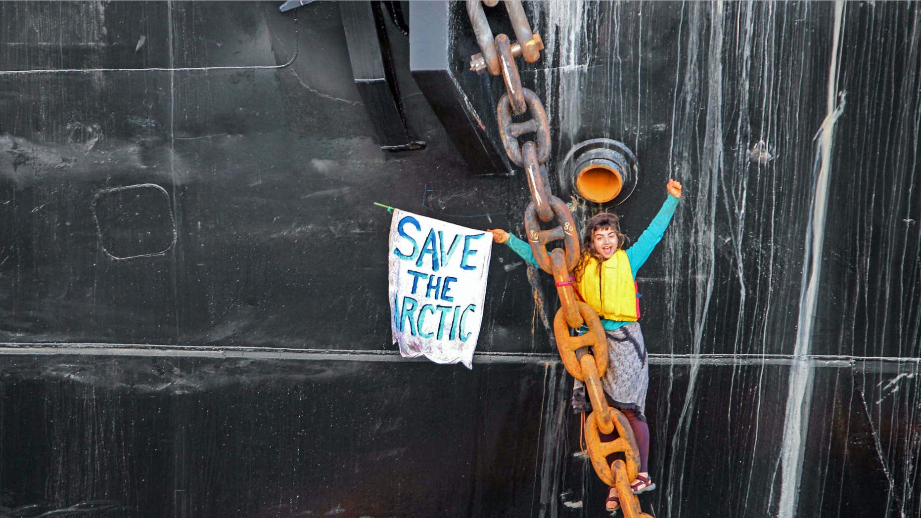 May 22, 2015: A woman identified as Chiara Rose has suspended herself in a climbing harness from the anchor chain of the Royal Dutch Shell support ship Arctic Challenger in the harbor at Bellingham, Wash.