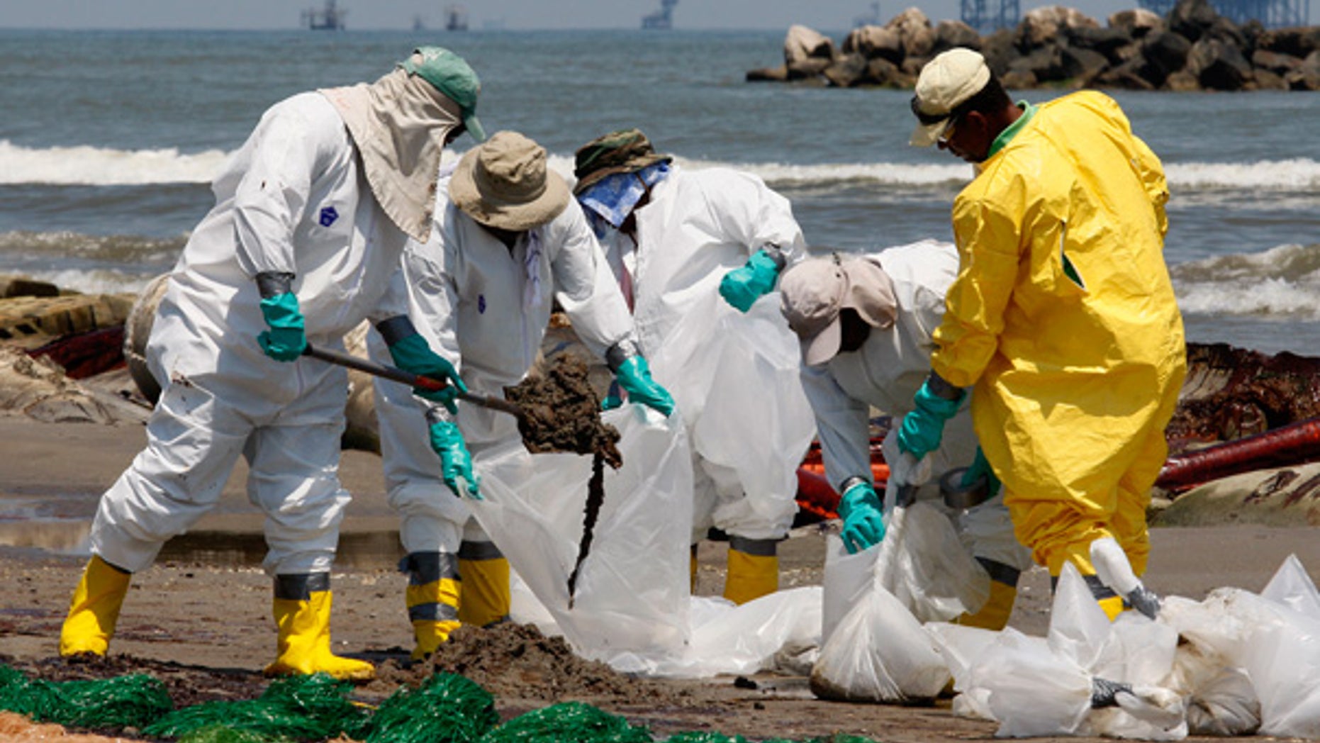 May 24: Workers shovel oil from the Deepwater Horizon spill off Fourchon Beach in Port Fourchon, La.
