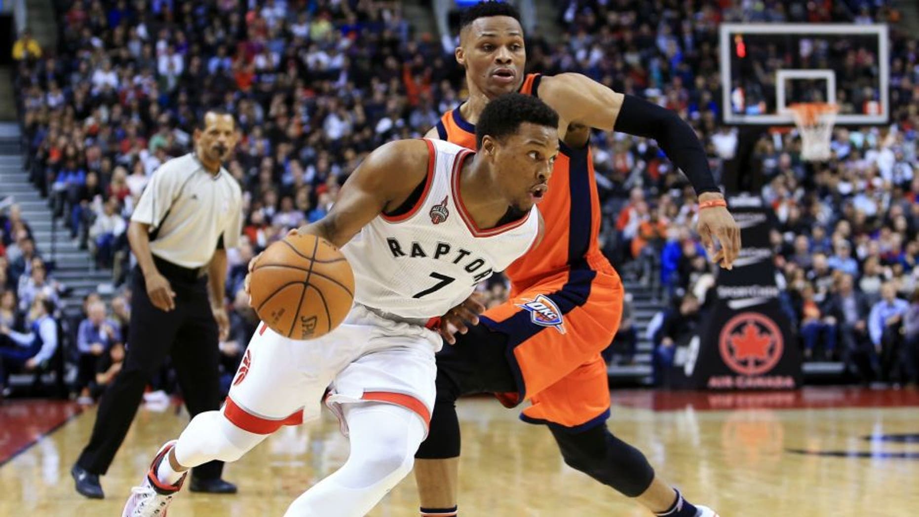 TORONTO, ON - MARCH 28: Kyle Lowry #7 of the Toronto Raptors dribbles the ball past Russell Westbrook #0 of the Oklahoma City Thunder during the second half of an NBA game at the Air Canada Centre on March 28, 2016 in Toronto, Ontario, Canada. NOTE TO USER: User expressly acknowledges and agrees that, by downloading and or using this photograph, User is consenting to the terms and conditions of the Getty Images License Agreement. (Photo by Vaughn Ridley/Getty Images)