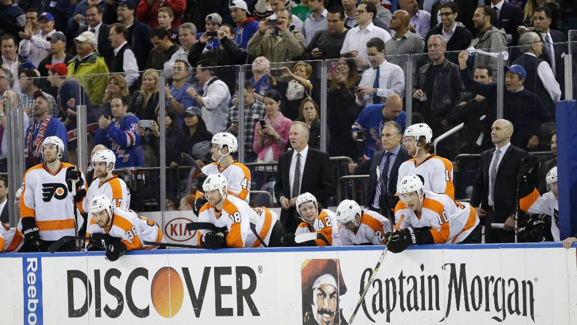 Philadelphia Flyers' Brayden Schenn (10), Matt Read (24), Jason Akeson (42) and Adam Hall (18) watch with teammates during the third period in Game 7 of an NHL hockey first-round playoff series against the New York Rangers, Wednesday, April 30, 2014, in New York. The Rangers won the game 2-1. (AP Photo)