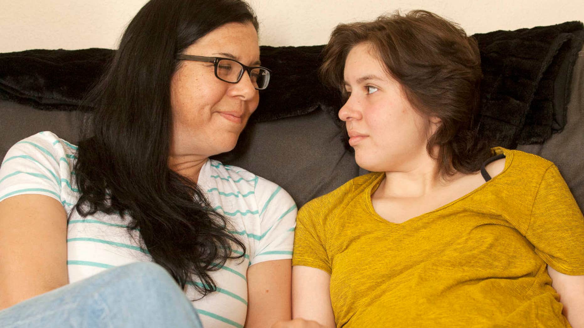 In this May 23, 2017 photo, Laura Polanco and daughter, Meredith Erck comfort each other while recalling months of fighting Erck's brain tumor while she tried to complete her high school course work in Rapid City, S.D.