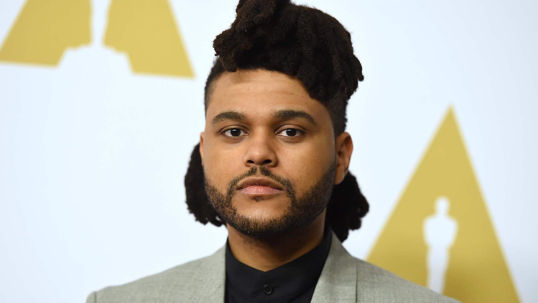 FILE - In this Feb. 8, 2016 file photo, The Weeknd arrives at the 88th Academy Awards nominees luncheon in Beverly Hills, Calif.