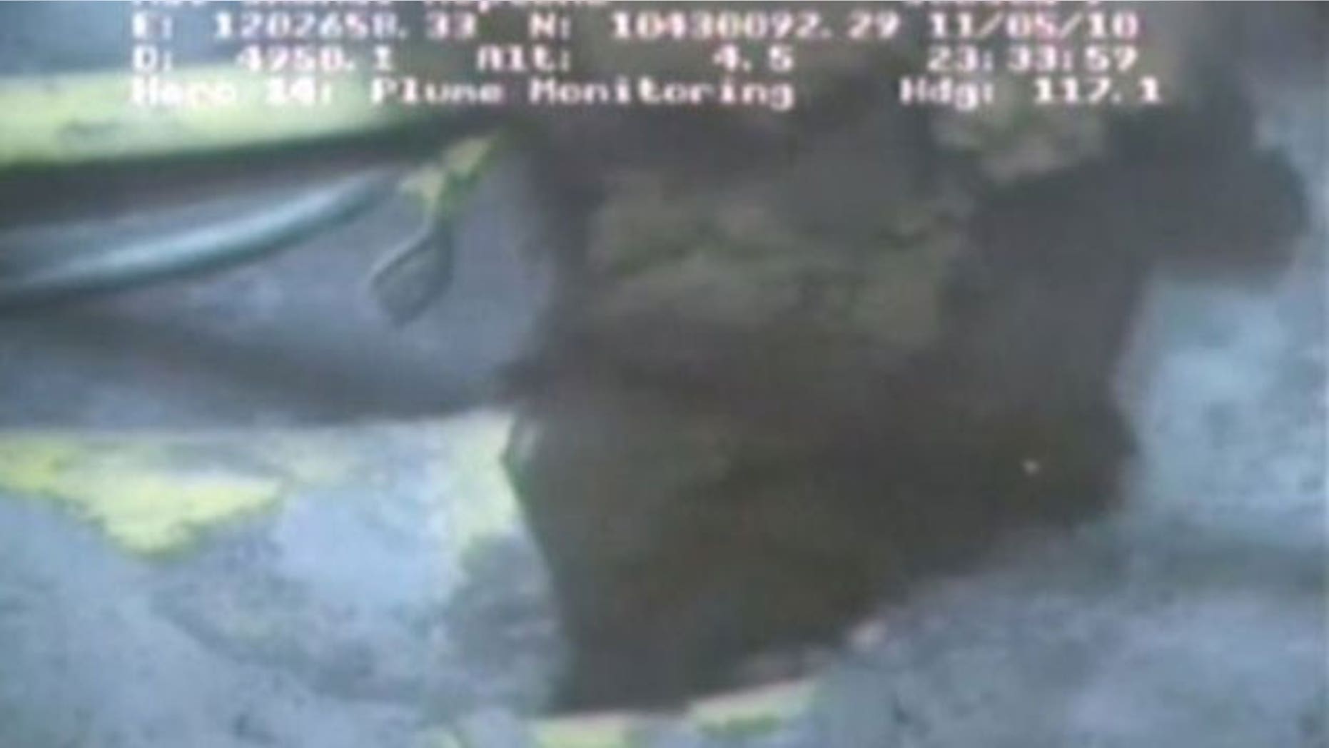 This image from a video released by BP shows oil spewing from a yellowish, broken pipe 5,000 feet below the surface (AP).
