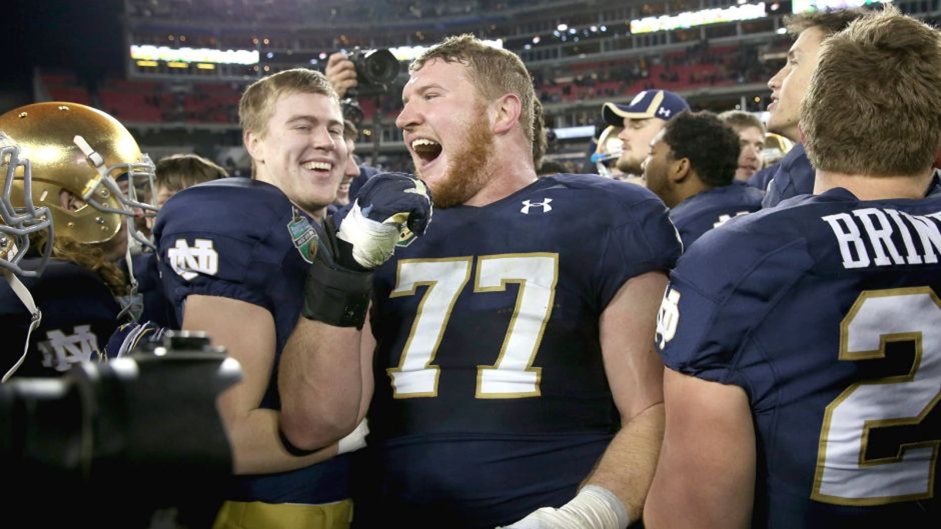 NASHVILLE, TN - DECEMBER 30: Matt Hegarty #77 of the Notre Dame Fighting Irish celebrates after beating the LSU Tigers in the Franklin American Mortgage Music City Bowl at LP Field on December 30, 2014 in Nashville, Tennessee. (Photo by Andy Lyons/Getty Images)