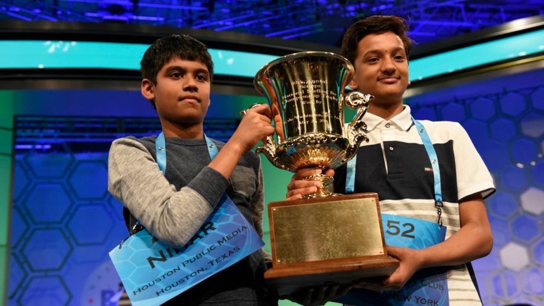 May 26, 2016; National Harbor, MD, USA; Nihar Janga, 11, of Austin, Texas (L) and Jairam Hathwar, 13, of Painted Post, N.Y. (R) celebrate as co-champions during the 2016 Scripps National Spelling Bee at the Gaylord National Resort and Convention Center.Mandatory Credit: Jack Gruber-USA TODAY NETWORK