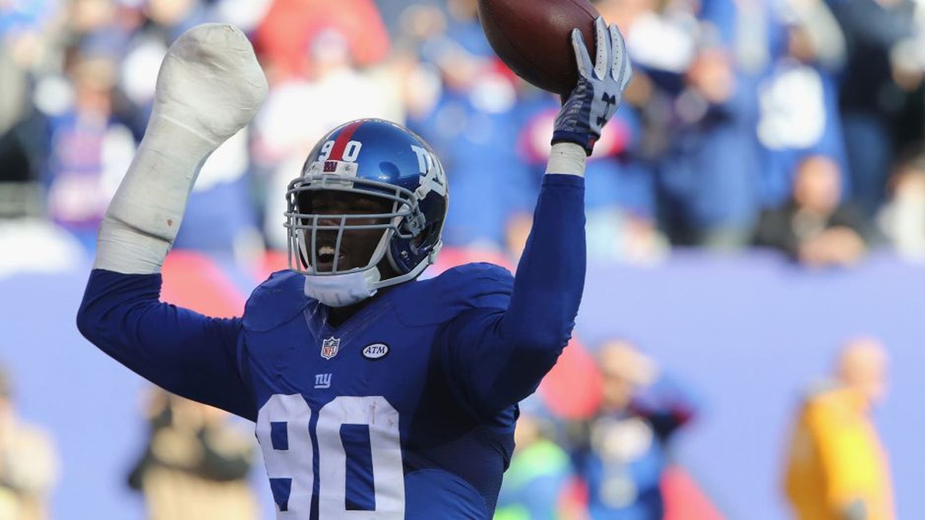Defensive End Jason Pierre-Paul #90 of the New York Giants has a fumble recovery against the New York Jets at MetLife Stadium on December 6, 2015 in East Rutherford, New Jersey. (Photo by Al Pereira/Getty Images for New York Jets)