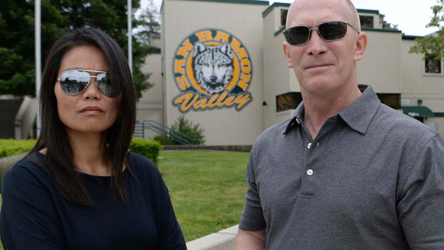 In this Friday, May 26, 2017 photo, parents Denise and Sean Lynch are photographed at San Ramon Valley High School in Danville, Calif.