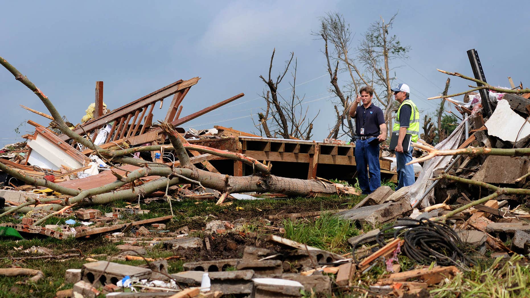 Meteorologists with the National Weather Service inspect the destruction Thursday morning, May 25, 2016, of a rural home north of Abilene, Kan.