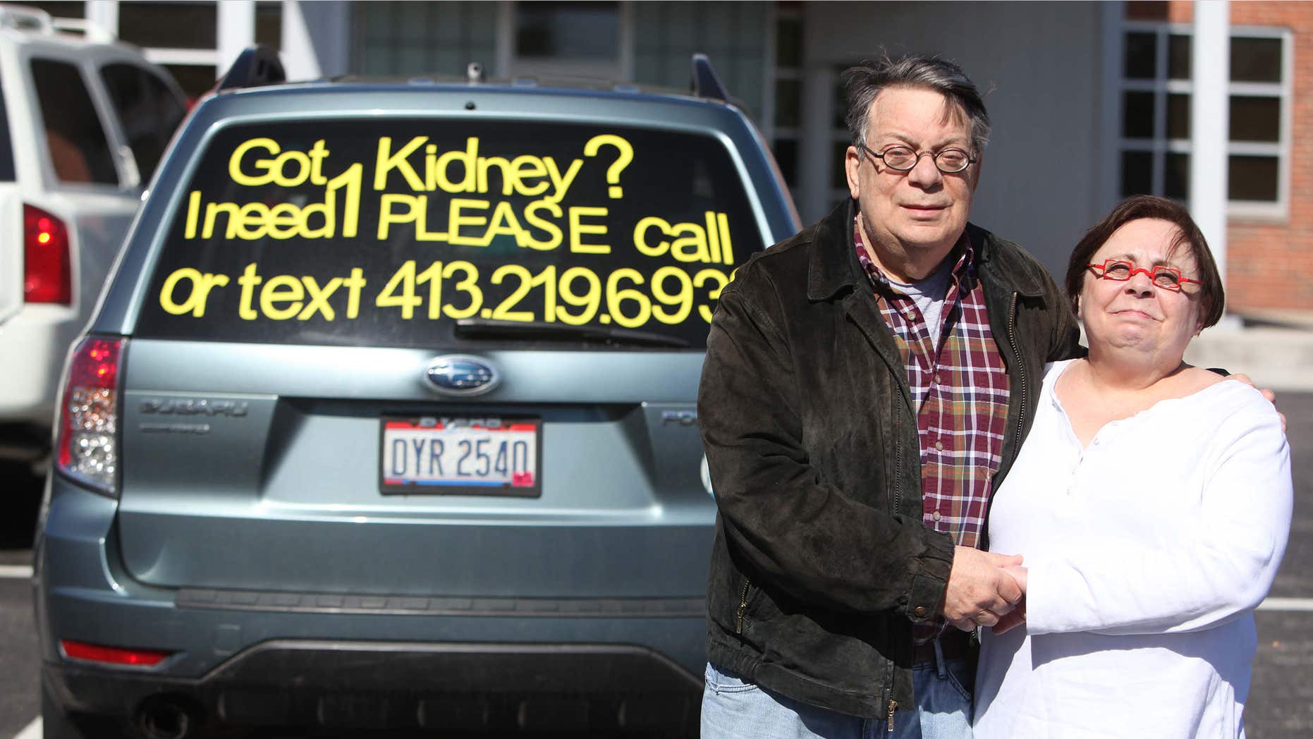 April 27, 2015: Photo shows Neal Raisman and wife Aileen posing for a photo in front of their SUV outside of the Fresenius Medical Care Campus Kidney Center in Columbus, Ohio.