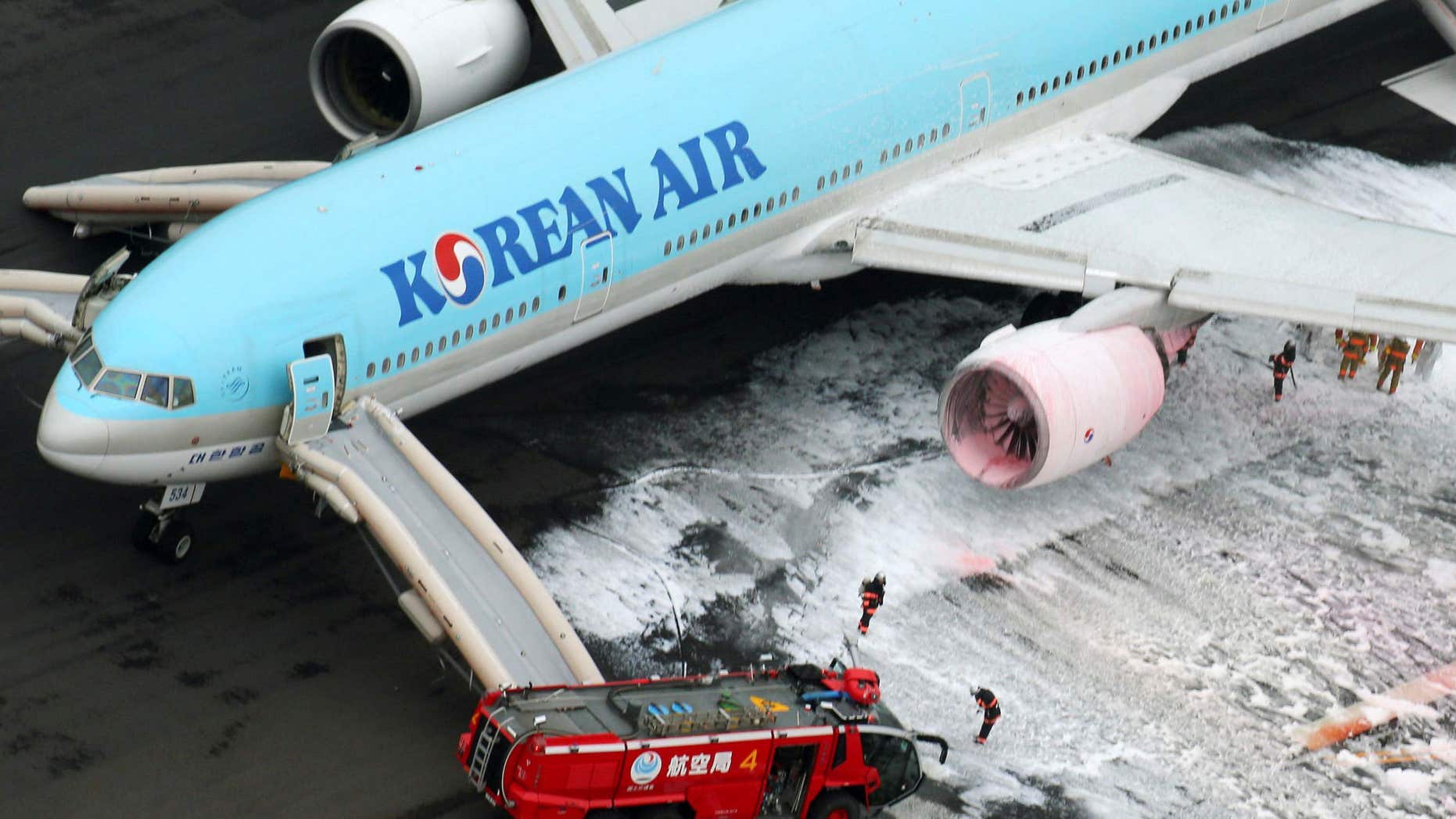 May 27, 2016: An aerial picture shows fire fighters spraying foam at the engine of a Korean Air Lines plane after smoke rose from it at Haneda airport in Tokyo, Japan.