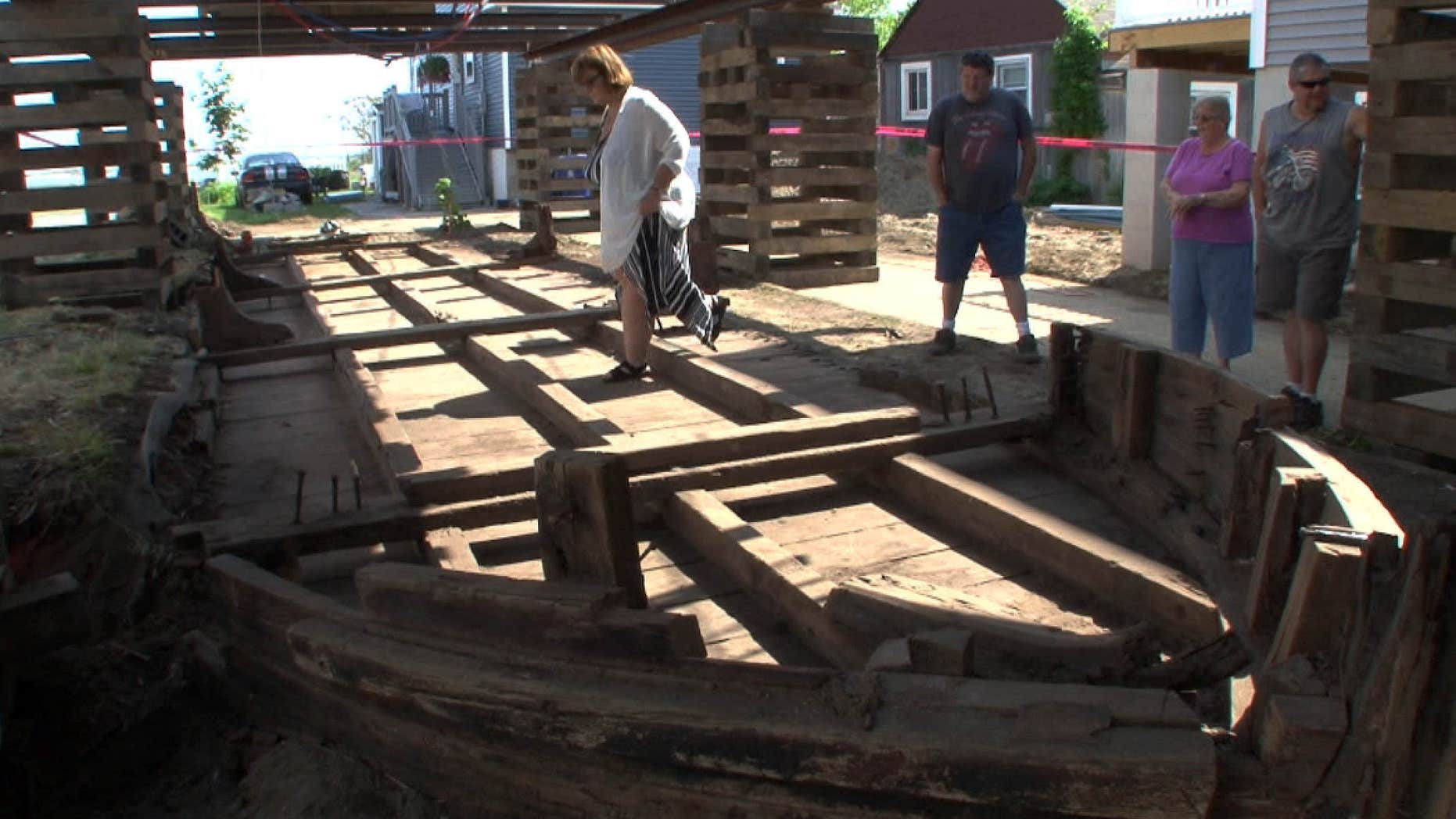 Eileen Scanlon, left, steps across a 44-foot wooden boat on Wednesday, May 25, 2016, underneath a home she rents in Highlands, N.J.
