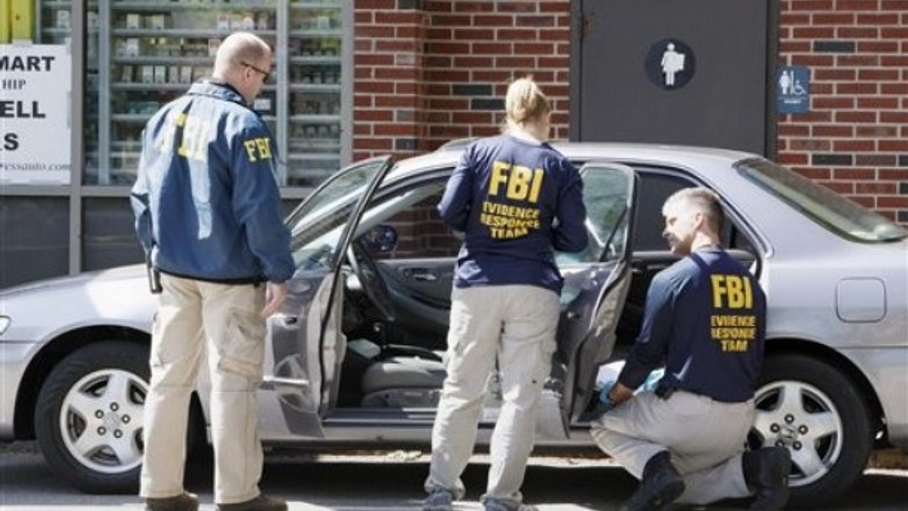 May 13: FBI investigators search a car at a service station in Brookline, Mass., in connection with the failed New York Times Square car bomb (AP).