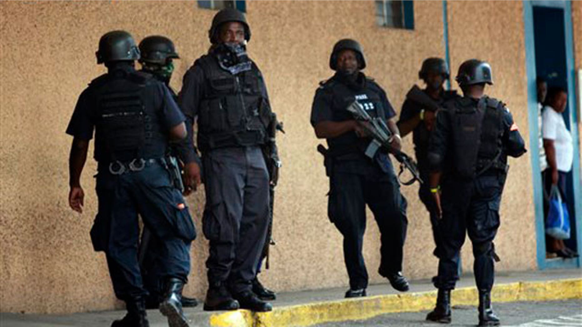 May 26: Police officers stand guard near the emergency room entrance of the national hospital in Kingston, Jamaica.