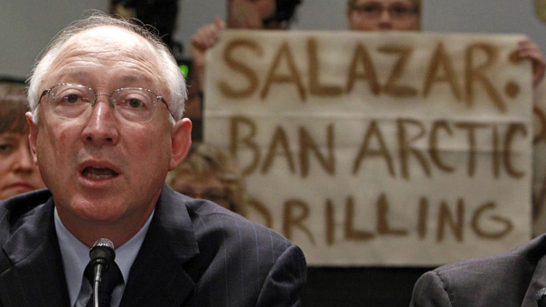 May 26: Greenpeace protesters hold up a banner as Secretary of the Interior Ken Salazar testifies before the House.