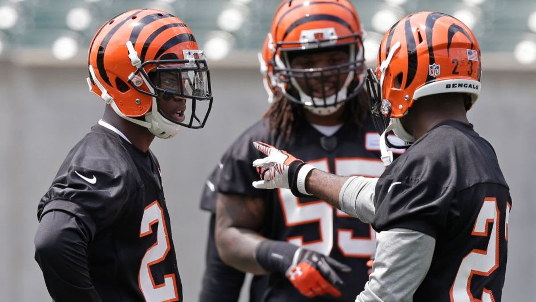Cincinnati Bengals first round draft pick Darqueze Dennard, a cornerback from Michigan State, left, gets instructions from veteran cornerback Terence Newman, right, during an NFL football organized team activity, Tuesday, May 27, 2014, in Cincinnati. (AP Photo/Al Behrman)