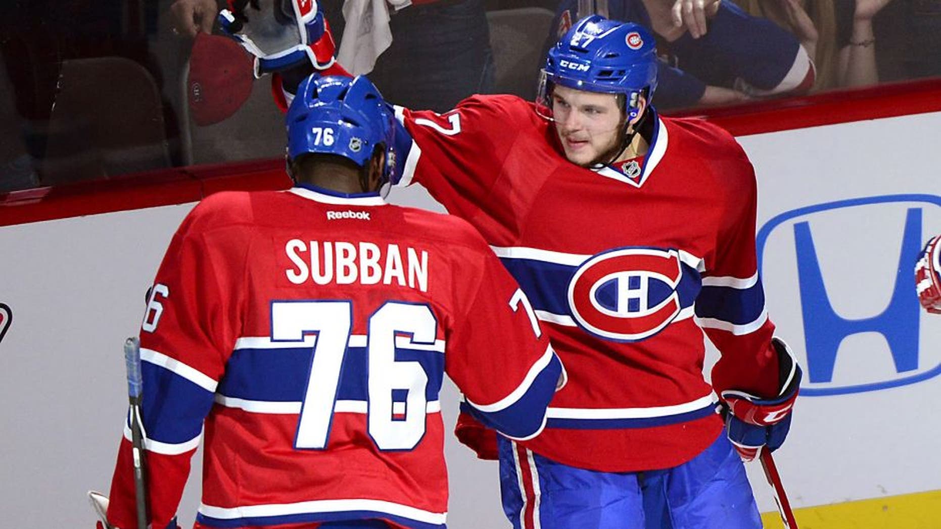 Montreal Canadiens' Alex Galchenyuk, right, celebrates with teammate P.K. Subban after scoring on New York Rangers goalie Henrik Lundqvist during the first period of Game 5 of the NHL hockey Stanley Cup playoffs Eastern Conference finals, Tuesday, May 27, 2014, in Montreal. (AP Photo/The Canadian Press, Paul. Chiasson)