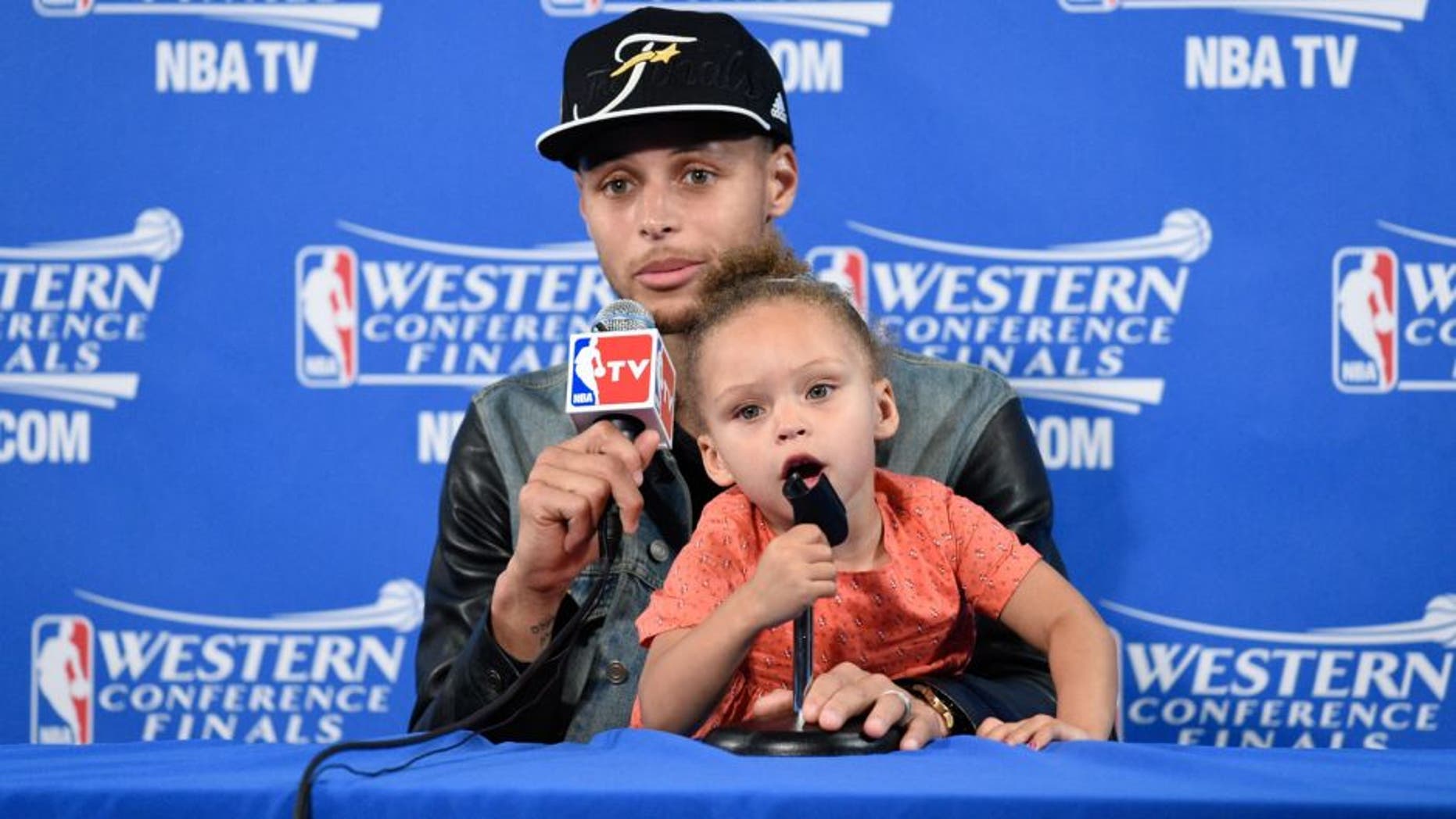 May 27, 2015; Oakland, CA, USA; Golden State Warriors guard Stephen Curry (30) and Riley Curry address the media in a press conference after game five of the Western Conference Finals of the NBA Playoffs against the Houston Rockets at Oracle Arena. Mandatory Credit: Kyle Terada-USA TODAY Sports