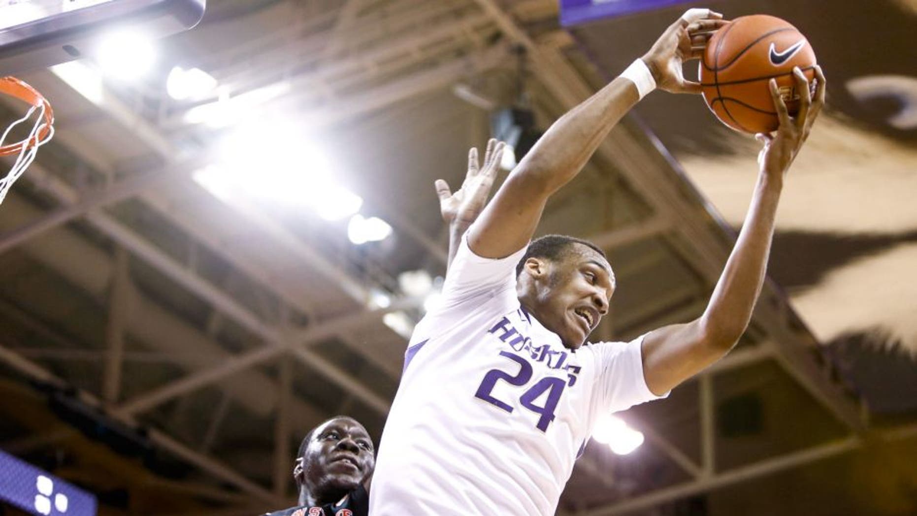 Jan 15, 2015; Seattle, WA, USA; Washington Huskies center Robert Upshaw (24) rebounds against Oregon State Beavers forward Jamal Reid (32) during the first half at Alaska Airlines Arena. Mandatory Credit: Joe Nicholson-USA TODAY Sports