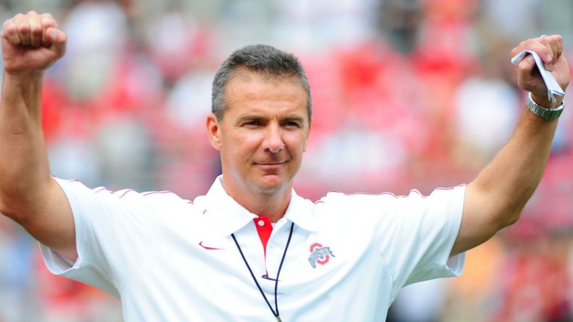 COLUMBUS, OHIO - SEPTEMBER 1, 2012: Head coach Urban Meyer of the Ohio State Buckeyes reacts to the chants of the fans before a game with the Miami Redhawks at Ohio Stadium in Columbus, Ohio. The Buckeyes won 56-10.(Photo by David Dermer/ Diamond Images/ Getty Images)