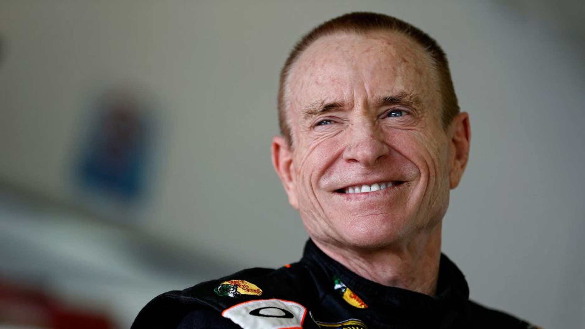 HOMESTEAD, FL - NOVEMBER 16: Mark Martin, driver of the #14 Bass Pro Shops / Mobil 1 Chevrolet, stands in the garage during practice for the NASCAR Sprint Cup Series Ford EcoBoost 400 at Homestead-Miami Speedway on November 16, 2013 in Homestead, Florida. (Photo by Jeff Zelevansky/NASCAR via Getty Images)