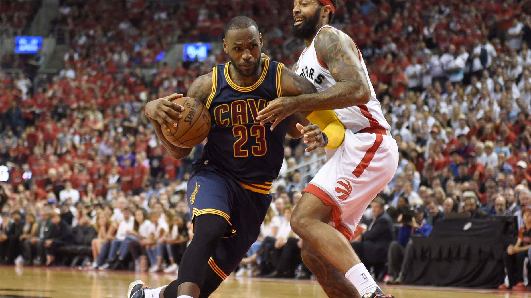 Cleveland Cavaliers forward LeBron James drives to the basket as Toronto Raptors forward James Johnson defends during the second half of Game 6 of the NBA basketball Eastern Conference finals, Friday, May 27, 2016, in Toronto.