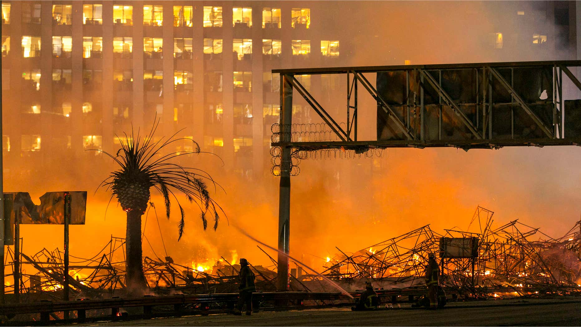 Dec. 8, 2014: In this file photo, Los Angeles firefighters battle a fire at an apartment building under construction next to the Harbor Freeway (Interstate 110) Freeway in Los Angeles.