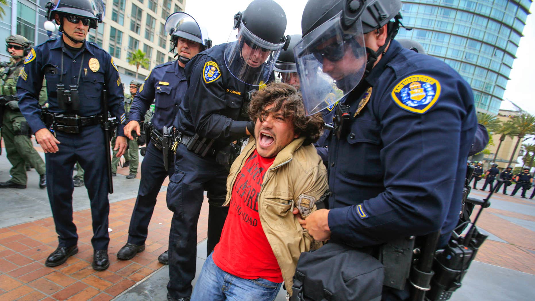 May 27, 2016: San Diego police officers in full riot gear arrest an anti Trump demonstrator near 5th Avenue and Harbor Drive in the Gaslamp Quarter after Republican presidential candidate Donald Trump held a rally at the San Diego Convention Center .