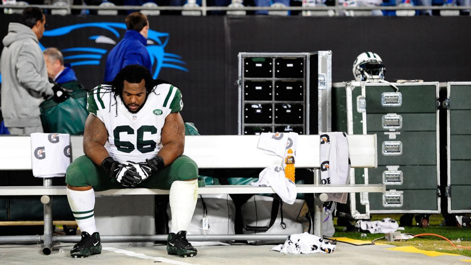 CHARLOTTE, NC - DECEMBER 15: Willie Colon #66 of the New York Jets sits alone on the bench after a loss to the Carolina Panthers at Bank of America Stadium on December 15, 2013 in Charlotte, North Carolina. The Panthers won 30-20. (Photo by Grant Halverson/Getty Images)