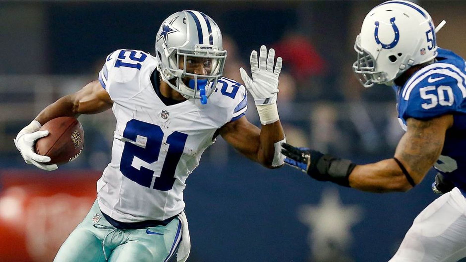 ARLINGTON, TX - DECEMBER 21: Joseph Randle #21 of the Dallas Cowboys carries the ball as Jerrell Freeman #50 of the Indianapolis Colts tries to position for the tackle in the first half at AT&T Stadium on December 21, 2014 in Arlington, Texas. (Photo by Tom Pennington/Getty Images)