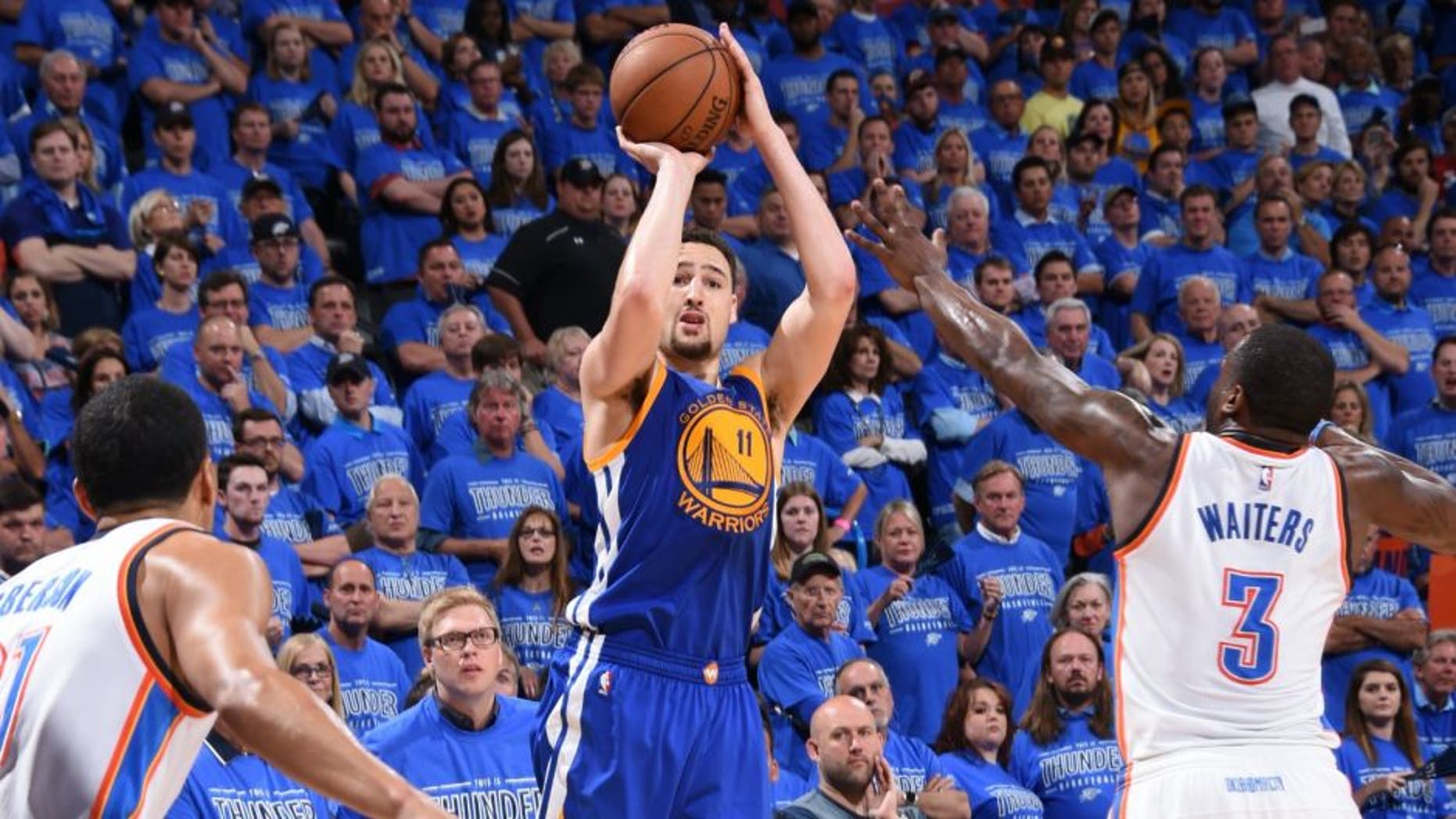 OKLAHOMA CITY, OK - MAY 28: Klay Thompson #11 of the Golden State Warriors shoots against Dion Waiters #3 of the Oklahoma City Thunder in Game Six of the Western Conference Finals during the 2016 NBA Playoffs on May 28, 2016 at Chesapeake Energy Arena in Oklahoma City, Oklahoma. NOTE TO USER: User expressly acknowledges and agrees that, by downloading and or using this photograph, User is consenting to the terms and conditions of the Getty Images License Agreement. Mandatory Copyright Notice: Copyright 2016 NBAE (Photo by Andrew D. Bernstein/NBAE via Getty Images)