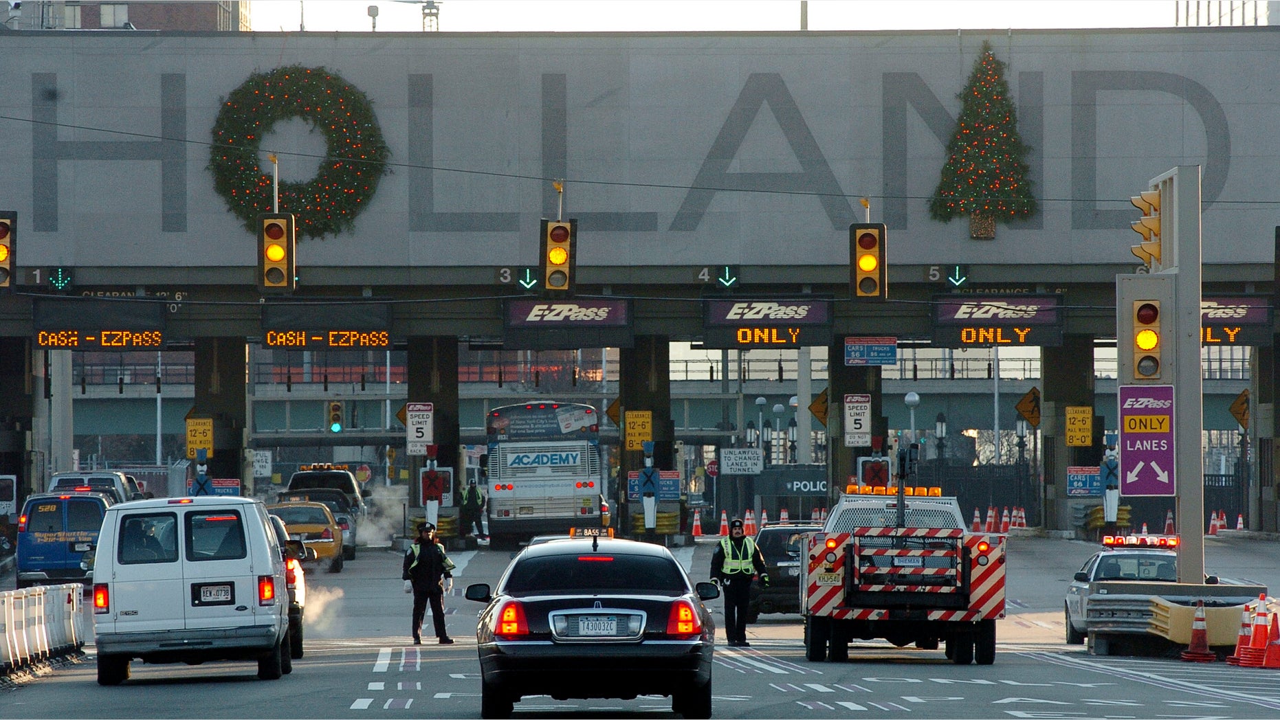 JERSEY CITY, NJ - DECEMBER 21: Port Authority police check vehicles at the Holland Tunnel check point on December 21, 2005 in Jersey City, New Jersey. Vehicles must have four or more occupants entering Manhattan below 96th Street from 5am and 11am. Subways and buses around New York remain offline as transit workers continue to strike for the second day. (Photo by Marko Georgiev/Getty Images)