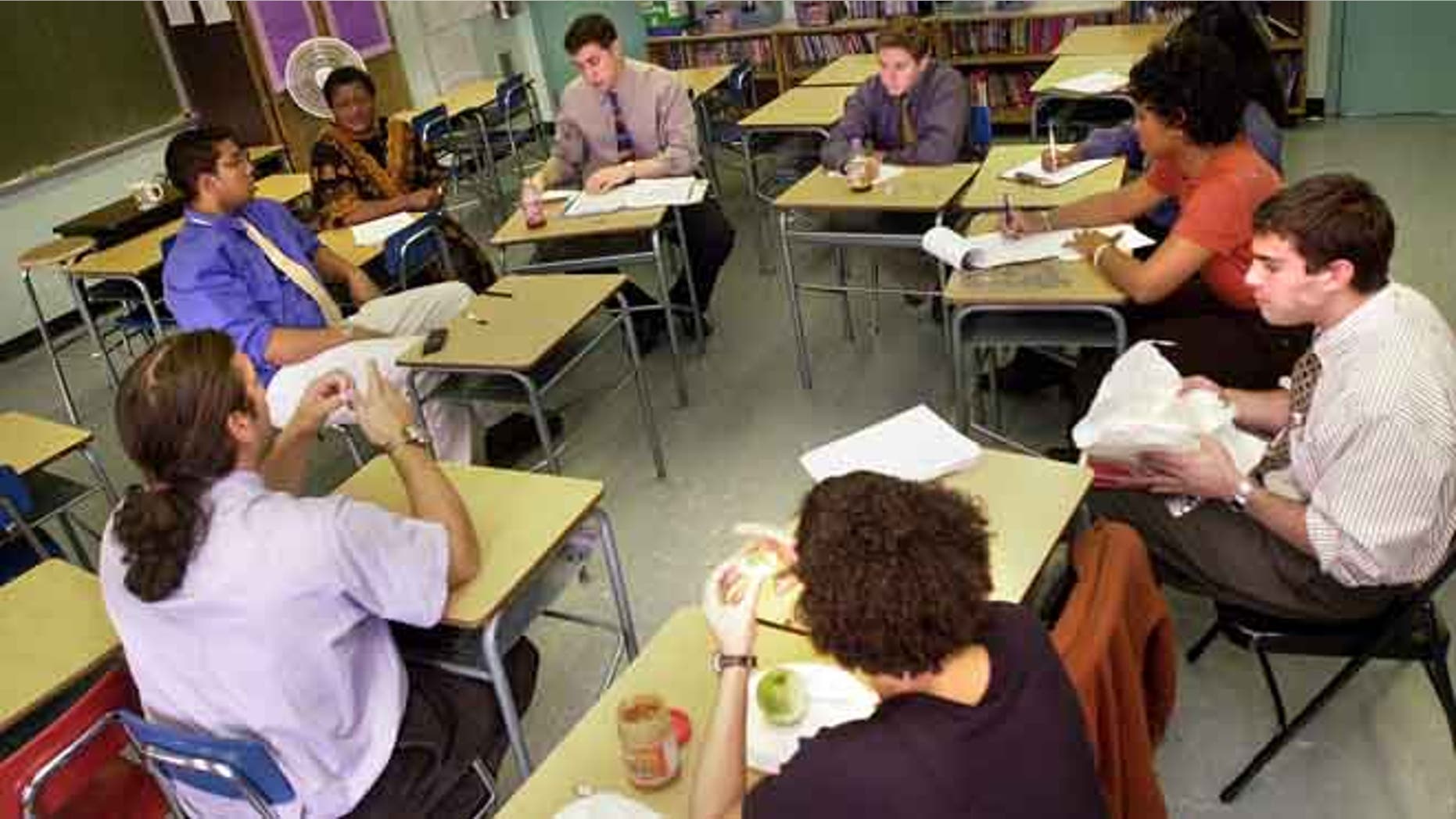 379693 05: Teachers and staff from "Knowledge is Power Program" (KIPP) Academy discuss student issues while their students are at lunch October 4, 2000 in The Bronx, New York. The Knowledge Is Power Program educates 200 middle-school students, mostly poor black and Latino neighborhood children, housed in a hallway on the fourth floor of a regular Bronx public schooI. Because of strict discipline where each student gets two hours of homework a night and a regular school day runs nine-and-a-half-hours, including Saturdays and throughout the summer, test scores are the highest in the Bronx. Governor George Bush of Texas, where another KIPP school is run, singled out KIPP for praise during his presidential debate against Vice President Al Gore. (Photo by Chris Hondros/Newsmakers)
