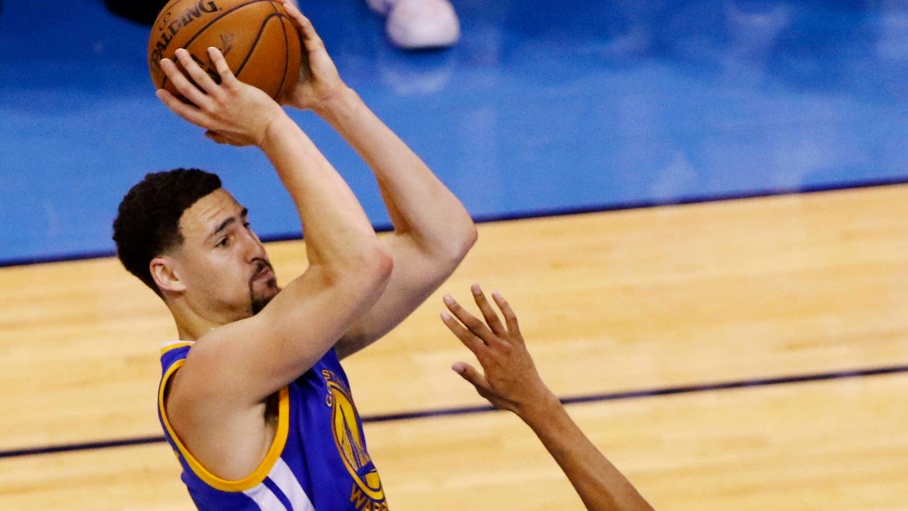 Golden State Warriors guard Klay Thompson (11) shoots over Oklahoma City Thunder guard Andre Roberson (21) during the first half in Game 6 of the NBA basketball Western Conference Finals in Oklahoma City, Saturday, May 28, 2016.