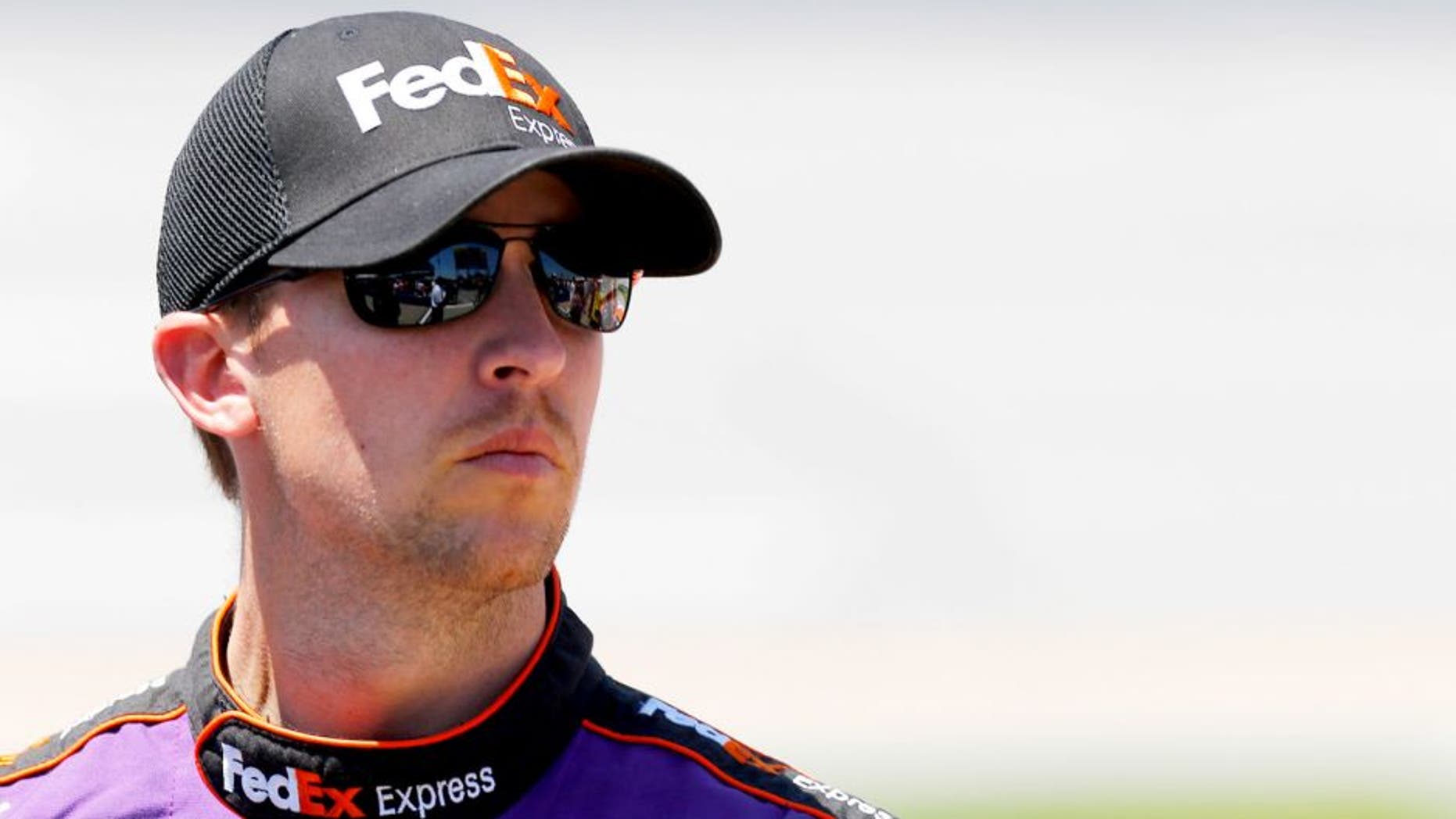 TALLADEGA, AL - MAY 02: Denny Hamlin, driver of the #11 FedEx Express Toyota, stands on the grid during qualifying for the NASCAR Sprint Cup Series GEICO 500 at Talladega Superspeedway on May 2, 2015 in Talladega, Alabama. (Photo by Jerry Markland/Getty Images)