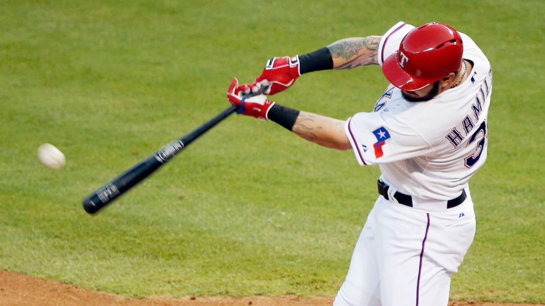 Texas Rangers Josh Hamilton makes contact for a solo home-run during the fourth inning of a baseball game against the Boston Red Sox, Friday, May 29, 2015, in Arlington, Texas. The home-run was Hamilton's second of the night. (AP Photo/Brandon Wade)