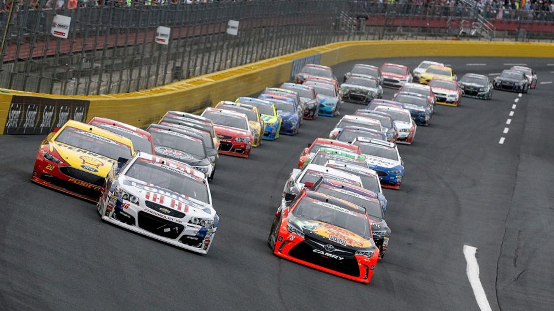CHARLOTTE, NC - MAY 29: Jimmie Johnson, driver of the #48 Lowe's Patriotic Chevrolet, and Martin Truex Jr., driver of the #78 Bass Pro Shops/Tracker Toyota, lead the field into turn one during the NASCAR Sprint Cup Series Coca-Cola 600 at Charlotte Motor Speedway on May 29, 2016 in Charlotte, North Carolina. (Photo by Brian Lawdermilk/Getty Images)