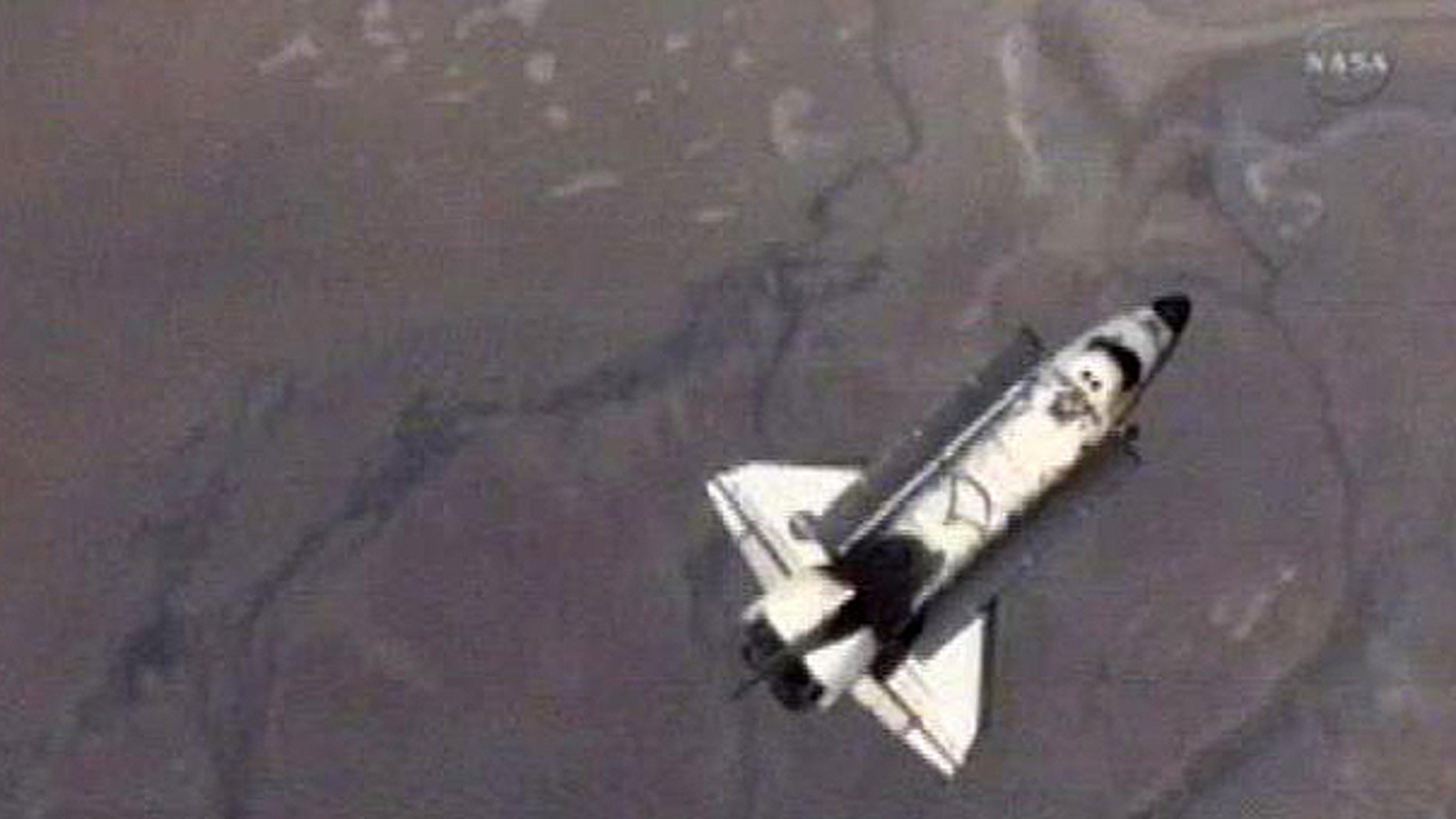 May 30: An image made from NASA Television shows the Endeavoour as it does it's fly around of the International Space Station before returning home on NASA's penultimate shuttle mission.
